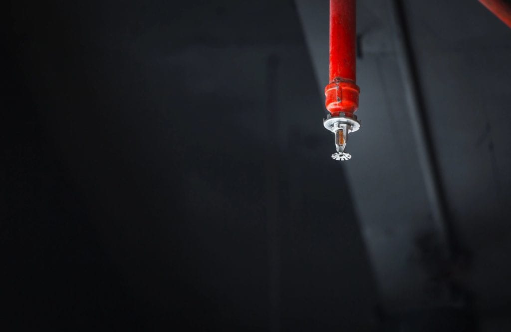 A red pole with a white knob on it